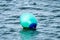 Green buoy swimming in the Atlantic Ocean