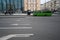 Green bus driving on the road with traffic arrows road signs