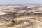 Green bushes grow on the hillside in middle East desert.