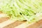 Green cabbage sliced on cutting board