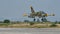 Green Camouflage Military Light Combat Jet Aircraft Landing in Slow Motion