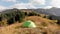 Green camping tent in the mountain forest