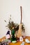Green candle, besom and dried herbs on altar