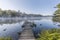 Green canoe and dock on a misty morning - Ontario, Canada