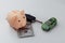 Green car with key, piggy bank and dollar banknotes on a white background. Savings and shopping concept