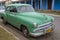Green car parked on street in Vinales, Cuba