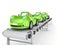 Green cars on conveyor.