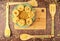 Green ceramic plate with dry fettuccine paste on a bamboo cutting Board and bamboo spatulas with paste on a dark wooden background