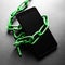 Green chains around the smartphone. Addicted to modern technologies