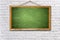 green chalk board on white brick wall