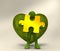 Green character holding a yellow jigsaw