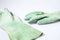 Green chemical gloves in a white background