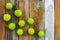 Green chestnuts on rustic wooden background