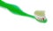 Green children`s toothbrush with toothpaste environmental