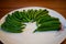 Green chillies arranged in beautiful pattern on a plate