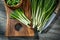 Green chopped onions on wooden cutting board  kitchen knife vintage wood background