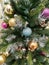 Green Christmas tree with colorful balls. Yellow  blue and crimson colors