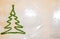 Green christmas tree from tinsel on snowflakes white background. snowy winter weather. merry christmas. xmas congratulation time.