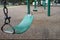 Green classic Sling Swing at kids park with safety rubber flexible flooring