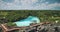 Green cliff ocean coast with limpid lake at tropic plants and trees in aerial view. Nature landscape