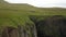 Green cliffs of farroe islands in cloudy weather