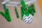 Green clothes peg hold one silver Litecoin