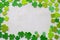 Green clovers with a white textured background