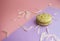 Green color macaron on purple background.