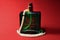 Green color perfume bottle isolated on red background. Men perfume on red silk background.