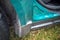 Green colored car wing and door covered with corrosive defect of iron. rust on the car. car wing with a hole. selective