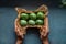 Green colored Easter eggs in crafted box in hands, traditional Easter decoration