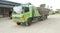 Green colored flatbed heavy trucks used to transport and distribute cements sacks from factory to points of sales or distributors