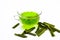 Green colored tea of lemon grass in a transparent cup isolated on white used in many ayurvedic treatments.