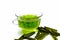 Green colored tea of lemon grass in a transparent cup isolated on white used in many ayurvedic treatments.