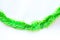 Green colors bunch fur or Christmas tree tinsel garland on white background. Christmas and New year celebration