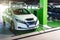 Green concept car. Hybrid vehicle - green technology of future. Electric car charge battery on eco energy charger station. Eco-