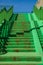 Green concrete stairs stairway with railing.