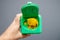 Green container cleared sharps disposal container man hand