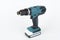 Green cordless hammer screwdriver drill on white background. The tool can be used as a drill hammer or a screwdriver or flat drill