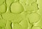 Green cosmetic clay cucumber facial mask, avocado face cream, green tea matcha body wrap texture close up, selective focus.