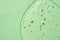 Green cosmetic textured gel background with bubbles. Copy space. Aloe vera gel