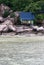 Green cottage on rocky cliff by the water