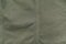 Green cotton military fabric background, close up