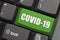 Green Covid 19 key on white color keyboard