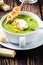 Green cream soup with poached egg