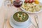 Green cream soup from spinach with croutons, cheese and fresh parsley