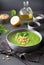 Green creamy cauliflower spinach soup on gray background