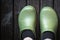 Green crocs clog worn by the man in black socks