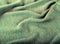 Green crumpled luxury cashmere background