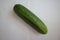 Green cucumber, fresh vegetables, kitchen background